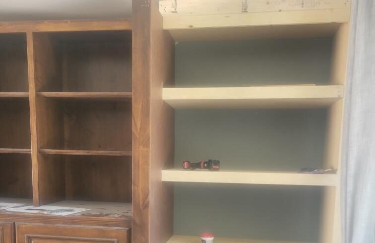 Built-in shelving rebuild — Dated stained built-ins rebuilt and refinished with a painted interior and new shelf runs.