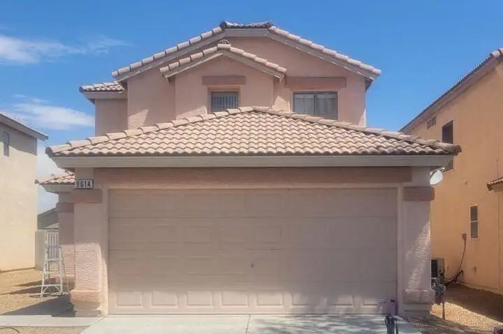 Two-story exterior repaint — Full stucco prep, patch, and repaint on a two-story residence including trim and garage.