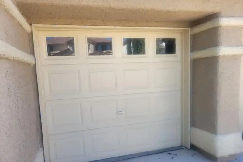 Garage door & surround — New garage door installation with block column detail and finished stucco surround.